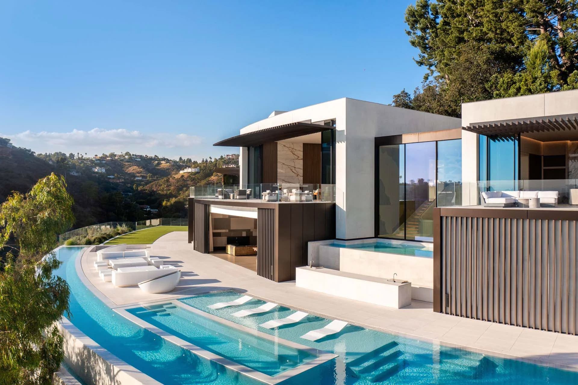 A contemporary home with a pool and spacious deck, perfect for relaxation and outdoor gatherings.